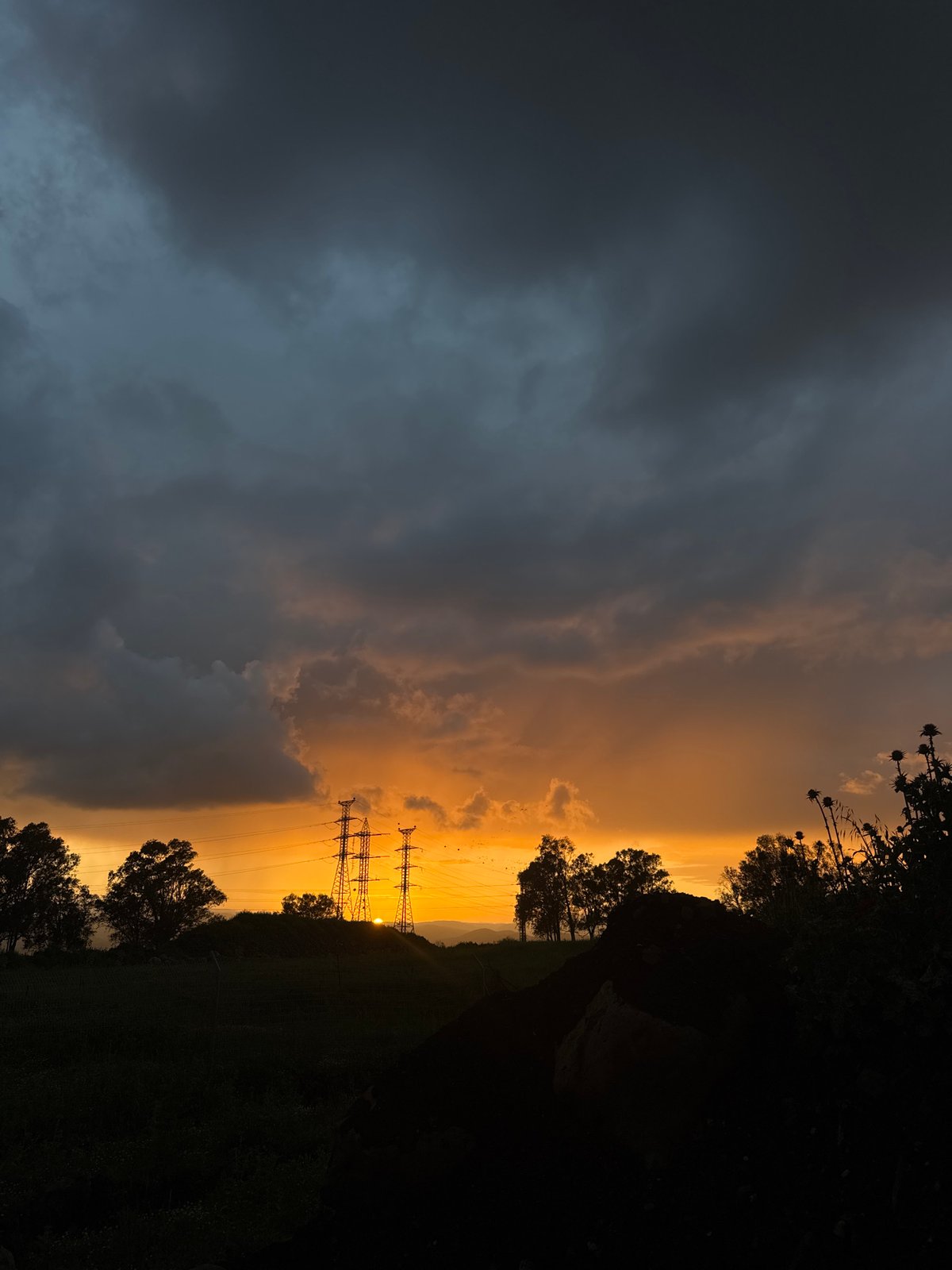 Dramatic sunset with contrasting storm clouds observed near Al Jizah