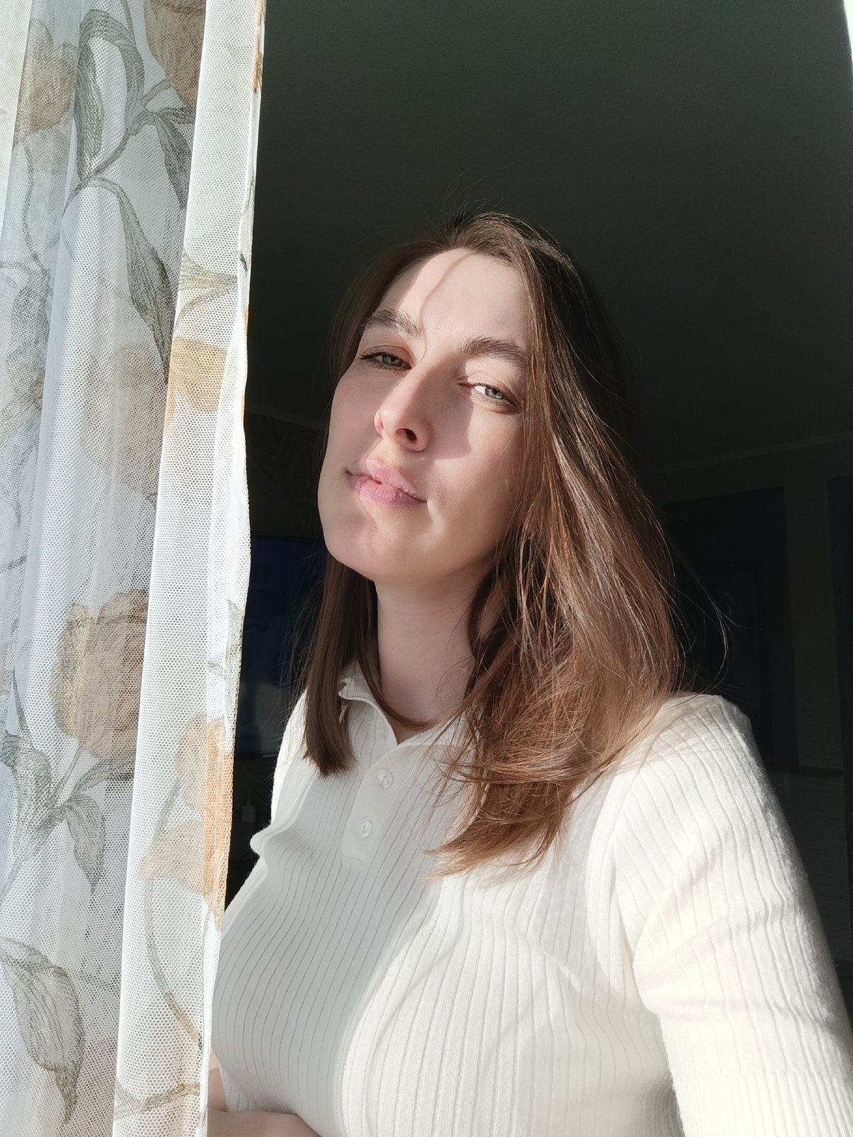 Woman photographed in sunlit indoor spaces in Фоки, Russia