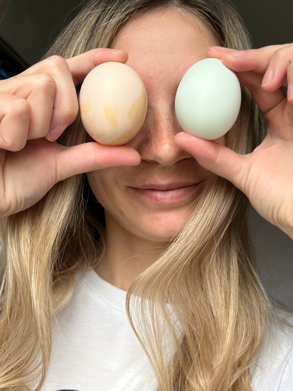 Person poses playfully with eggs over eyes in Chaikovsky