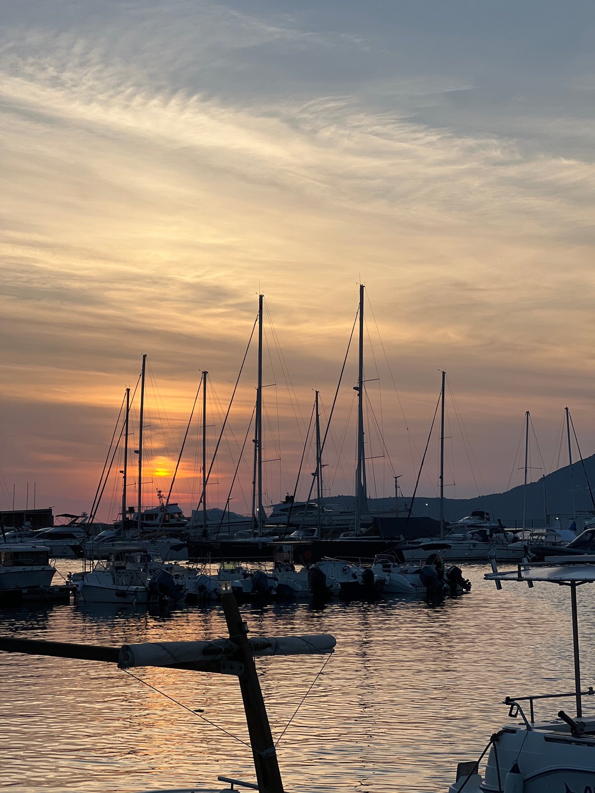 Sunset over Bar's Adriatic harbor, cruise ship offshore