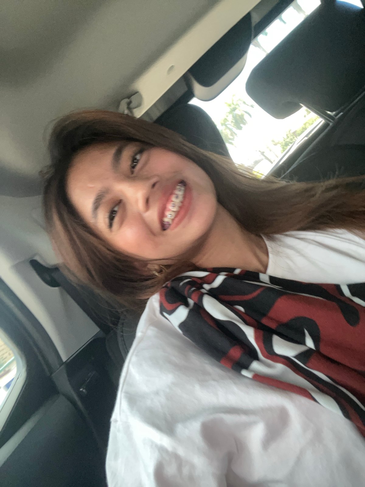 Smiling portrait in Tagum, Philippines, patterned scarf.