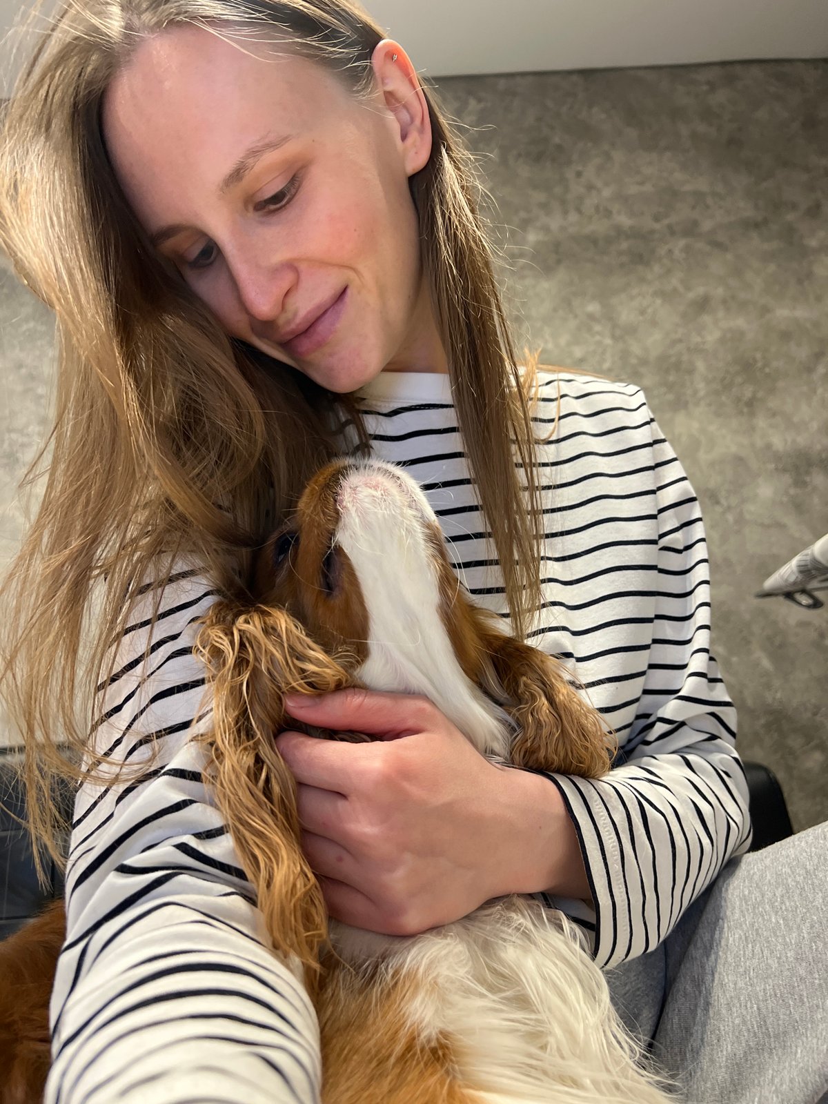 Woman and dog share quiet indoor moment in Khimki