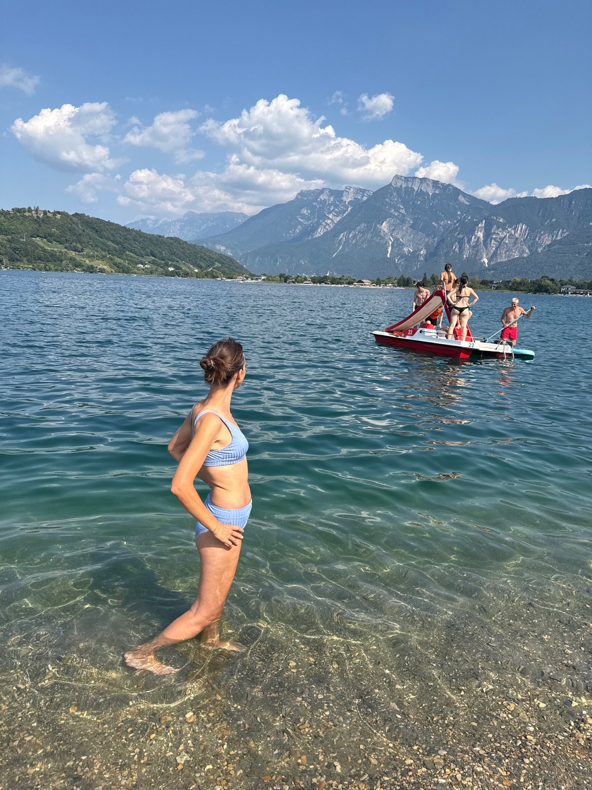 Summer afternoon on an Italian Alpine lake, boats and paddleboards out