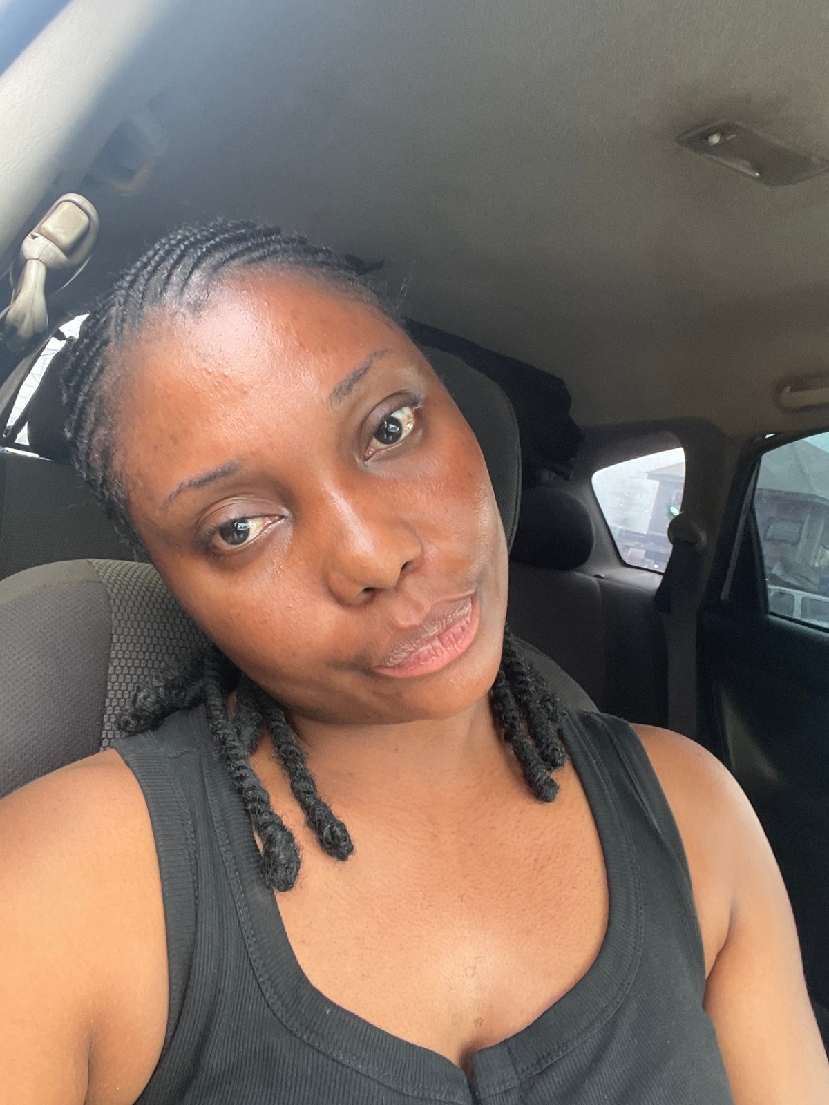 Woman passenger travels through busy Jos streets