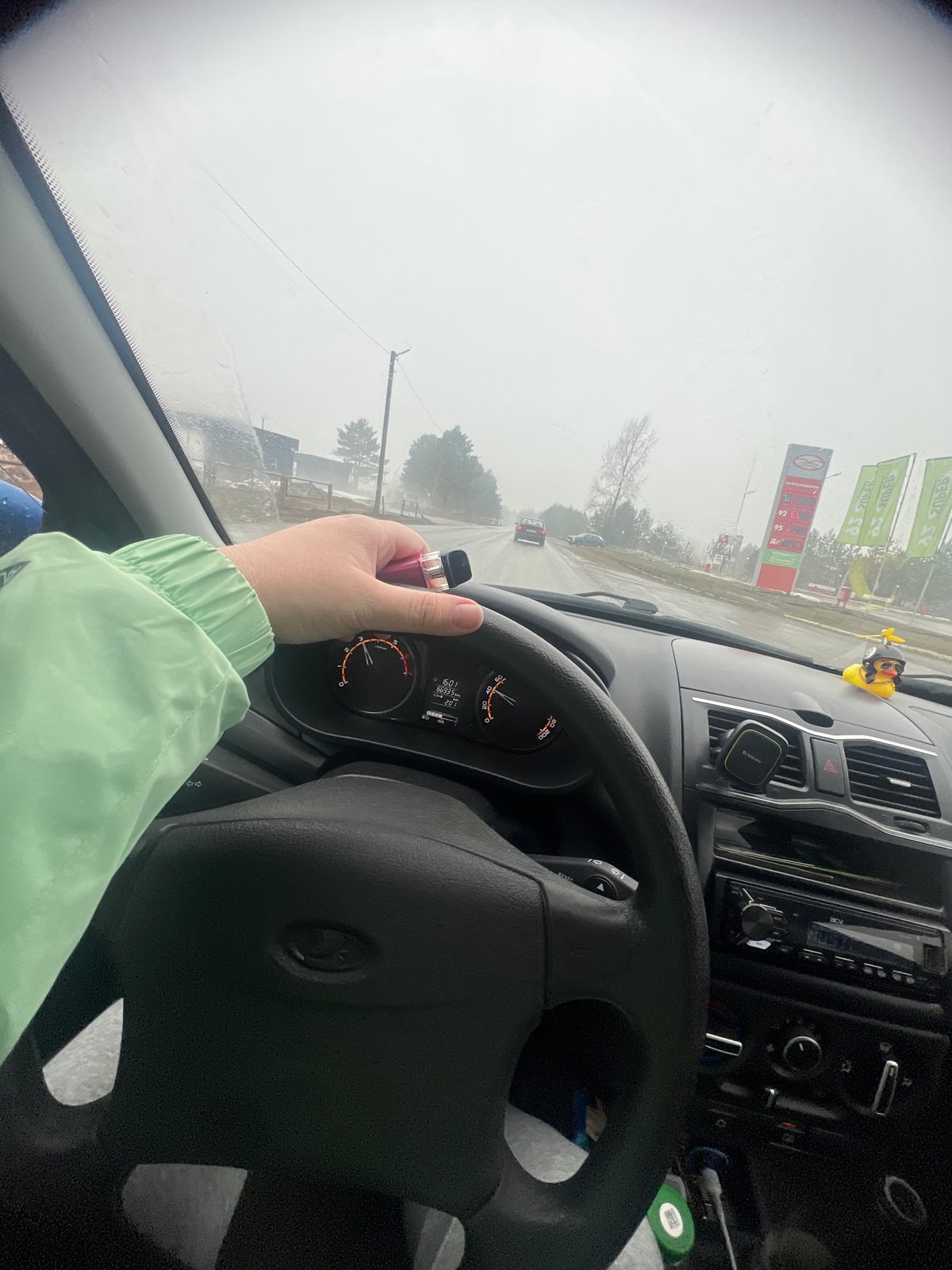 Driver vapes in vehicle during snowy weather in Chaikovsky