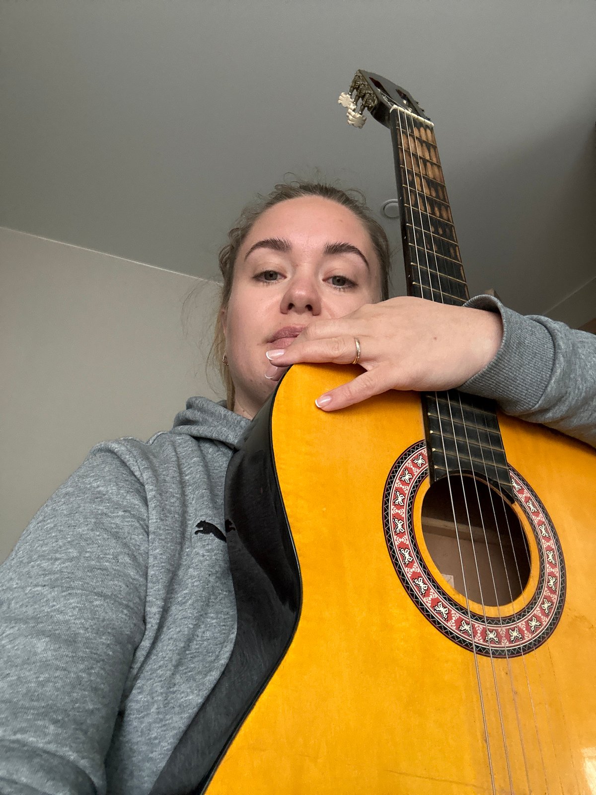 Woman practices guitar at home in rural Russia