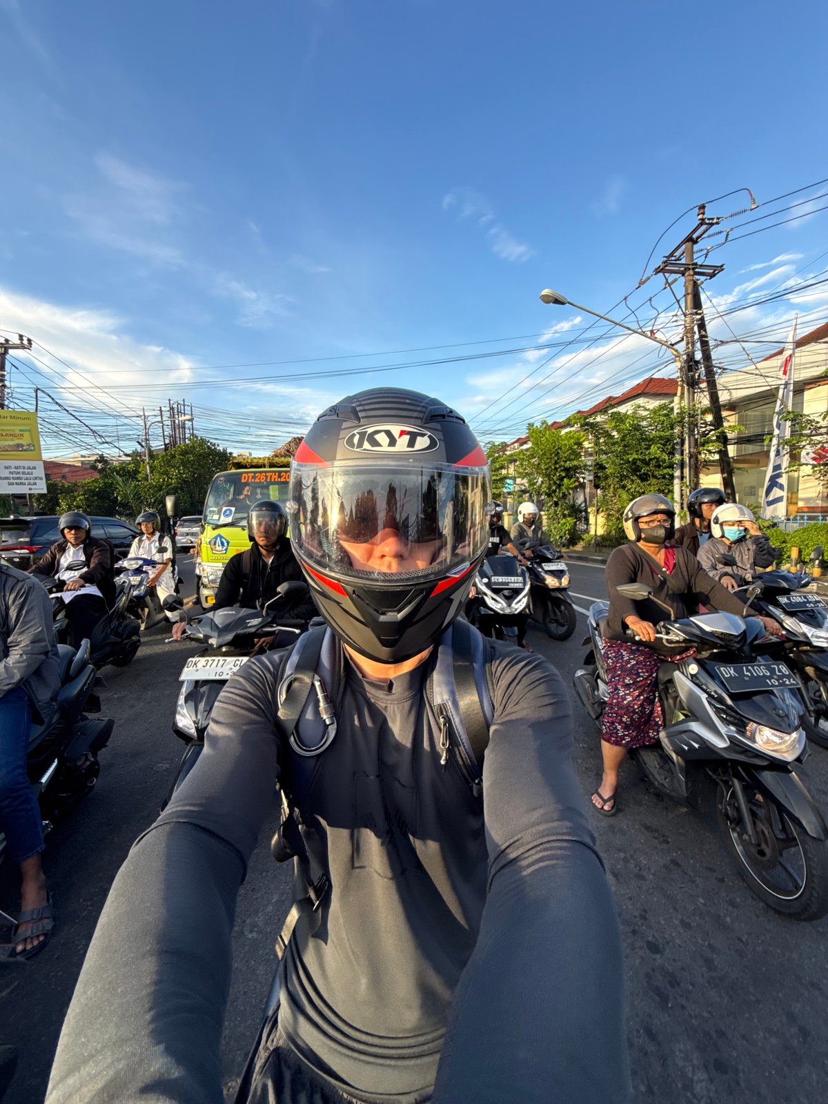 Motorcyclist spotted at Denpasar intersection during evening traffic