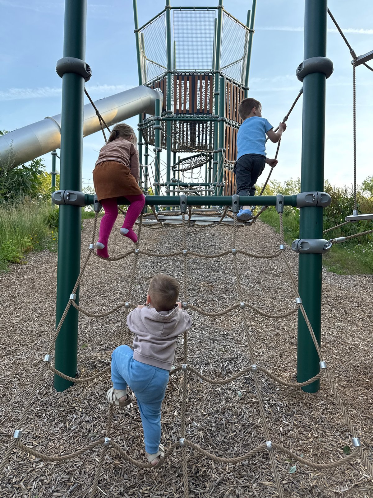 Afternoon play session at a rustic sand and wood playground