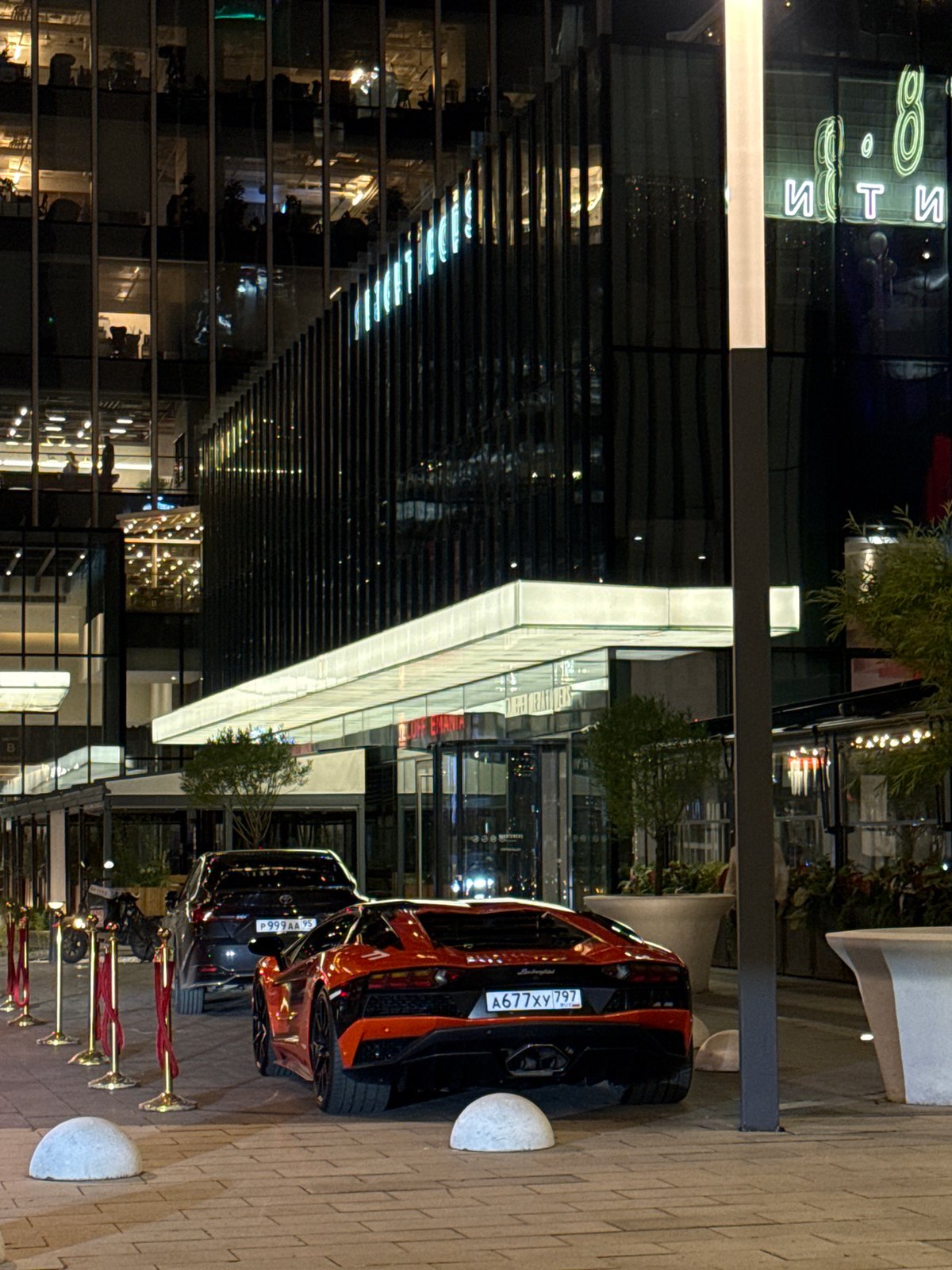 Luxury cars spotted parked near modern building in Khimki