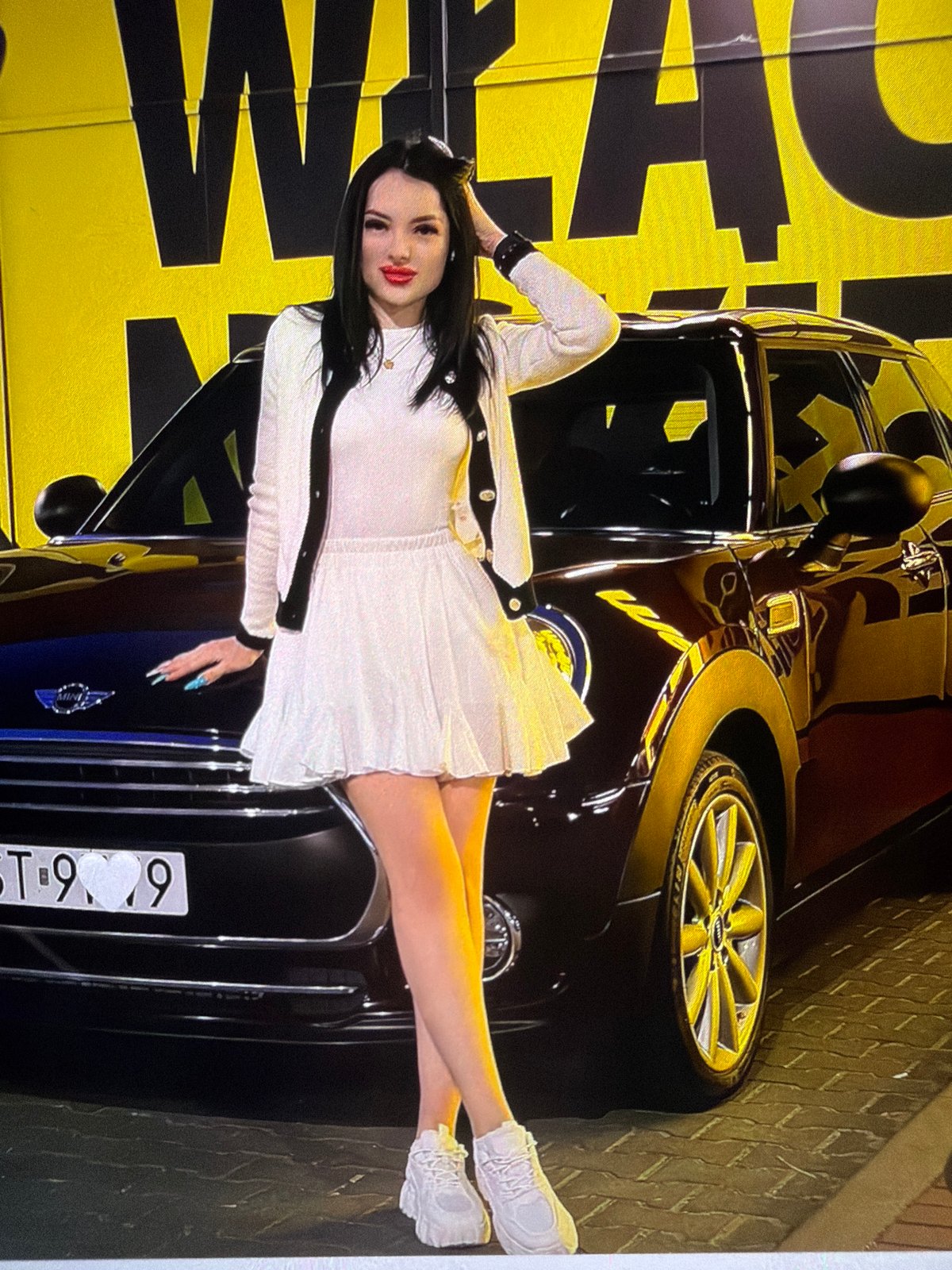 White outfit, lakeside platform, and a black cat in Strzelce Opolskie
