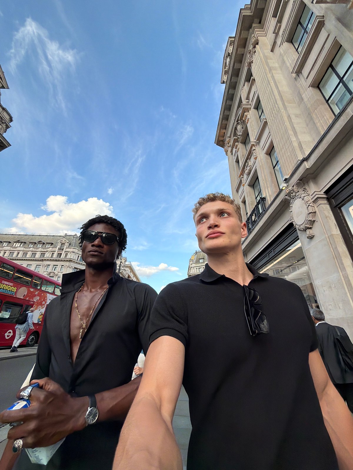 Pedestrians moving through a busy London street on a summer afternoon