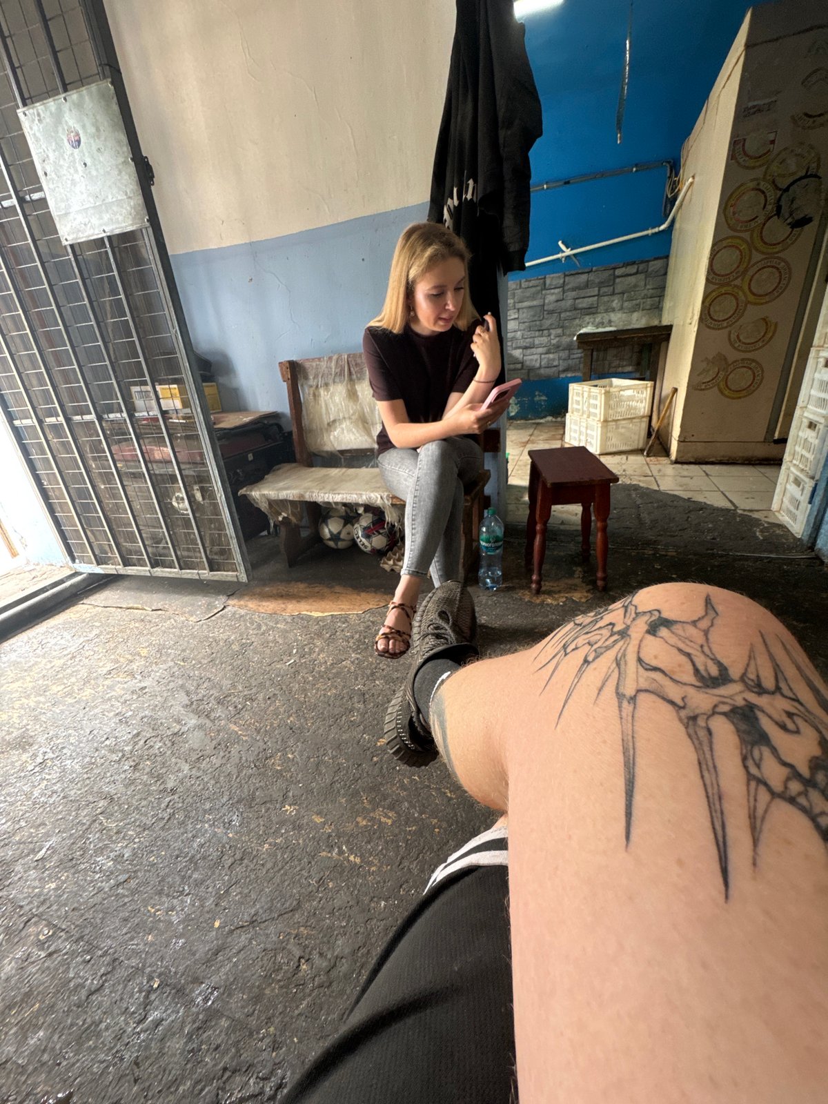 Small group kills time outside a weathered building