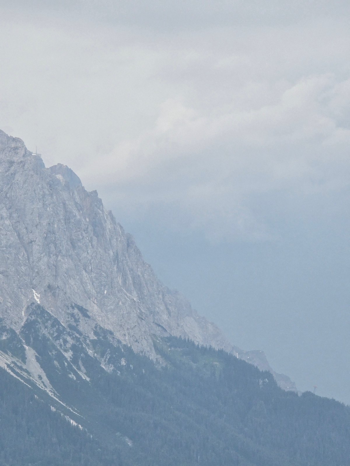 Garmisch-Partenkirchen rooftops and misty Alps on a cloudy afternoon