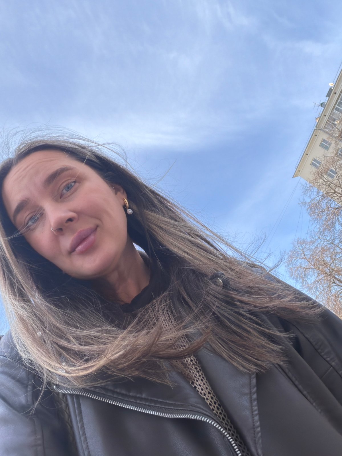 Woman films selfie video in windy Moscow courtyard