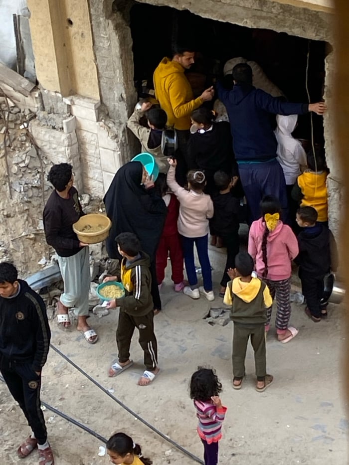 Crowds gather at damaged buildings in Khan Yunis