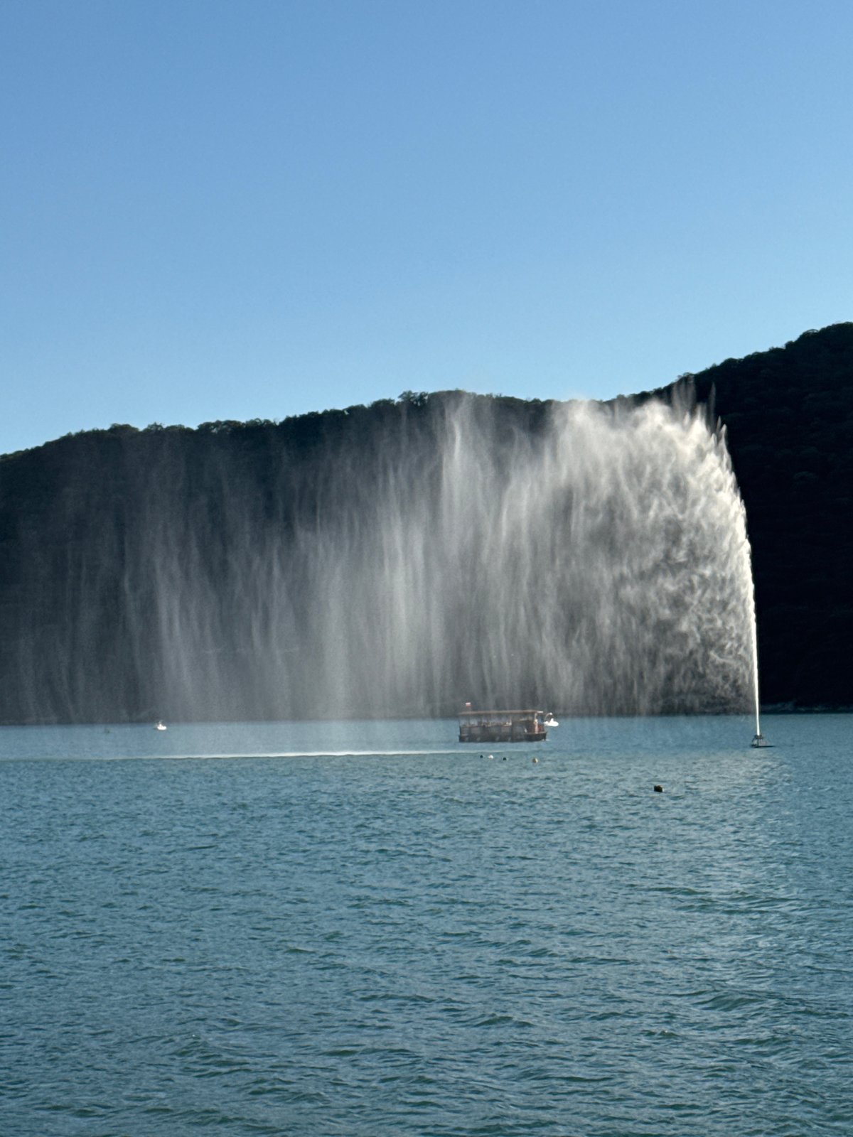Busy afternoon at Abrau-Dyurso waterfront with fountain and tourists