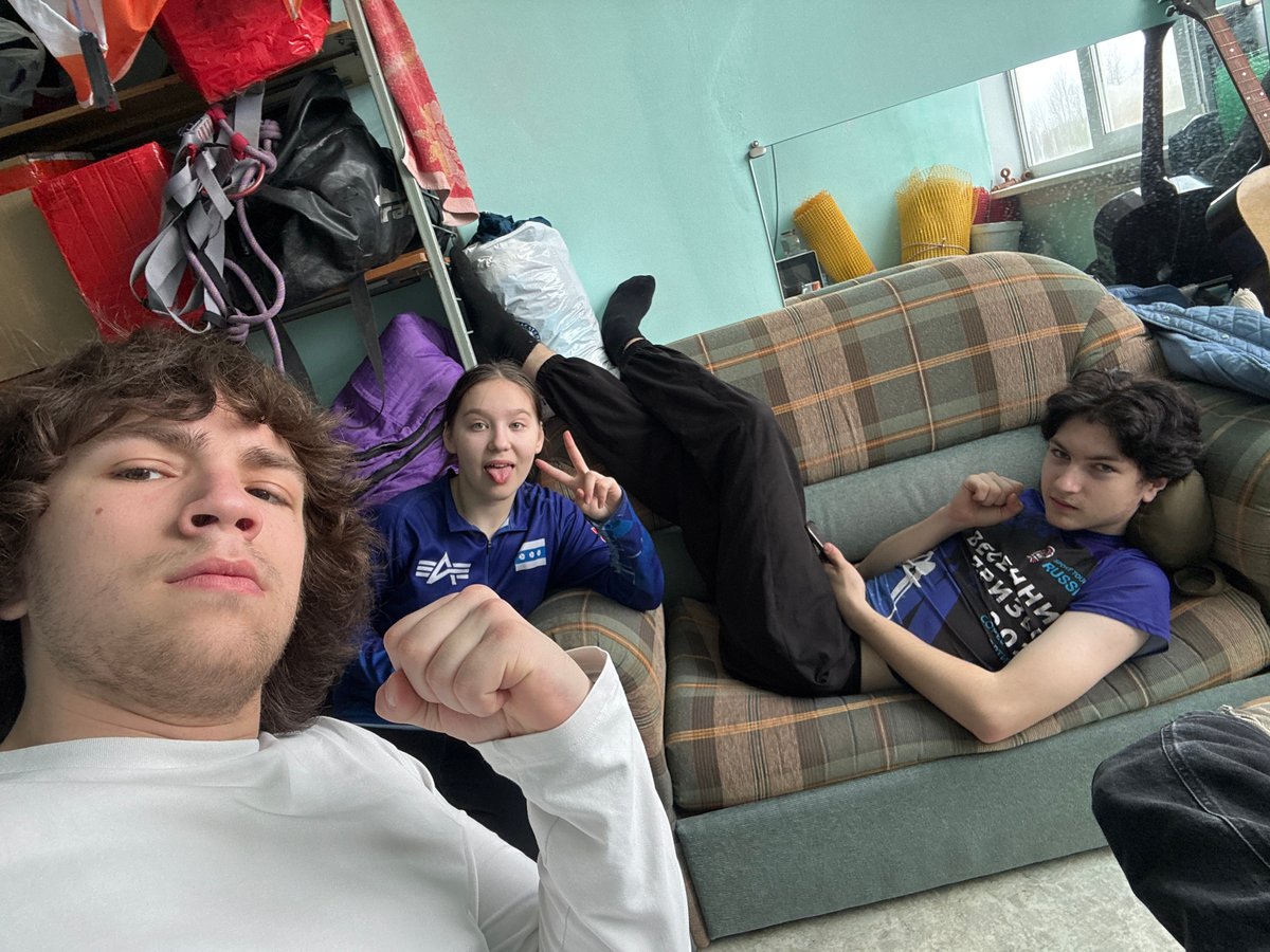 Three people photographed lying upside down on couch in Berezniki
