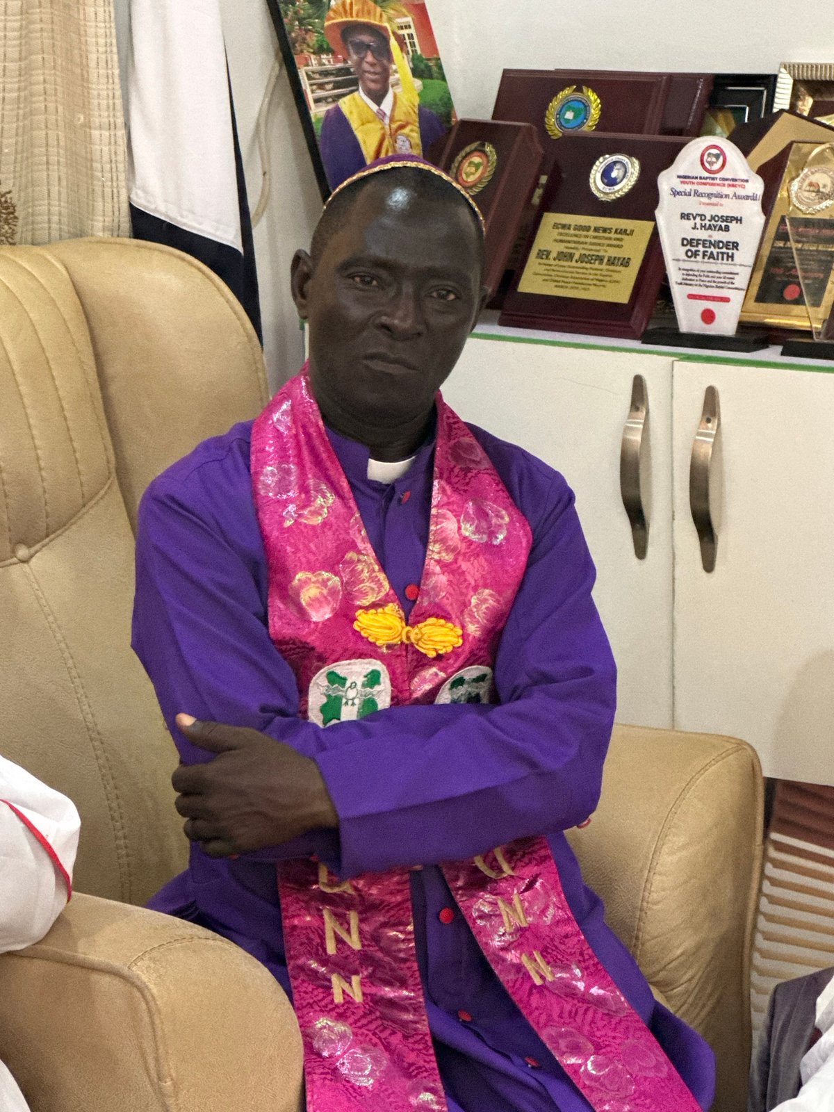 Clergy meeting in Narayi, Nigeria, with colorful vestments and prayer