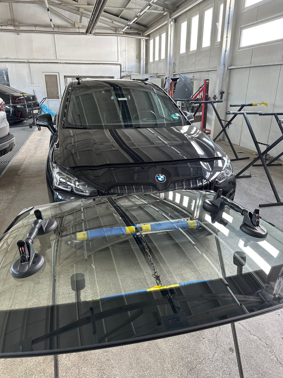 BMW receives windshield service at automotive workshop