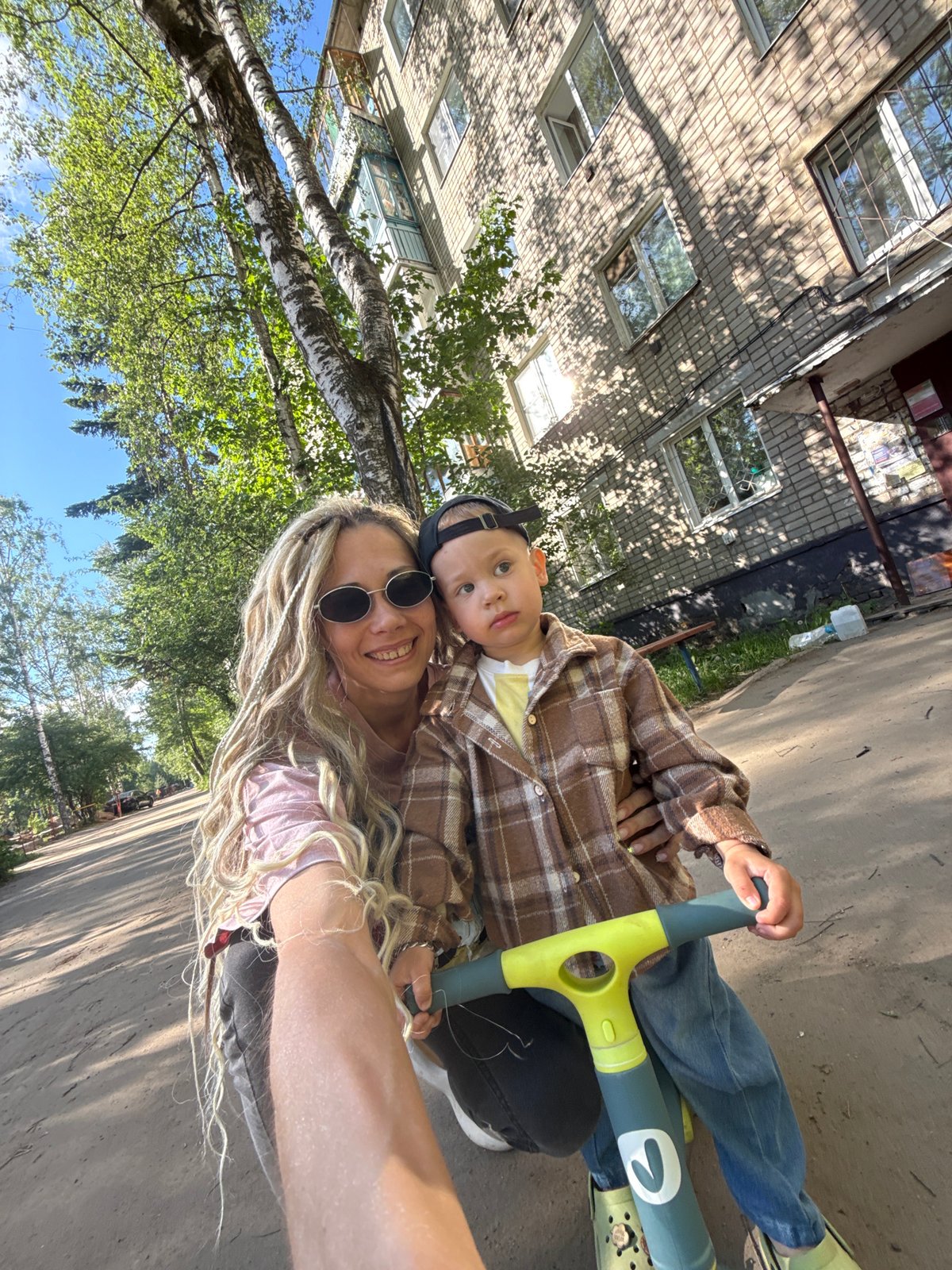 Mother and child share scooter moment in Rusanovo
