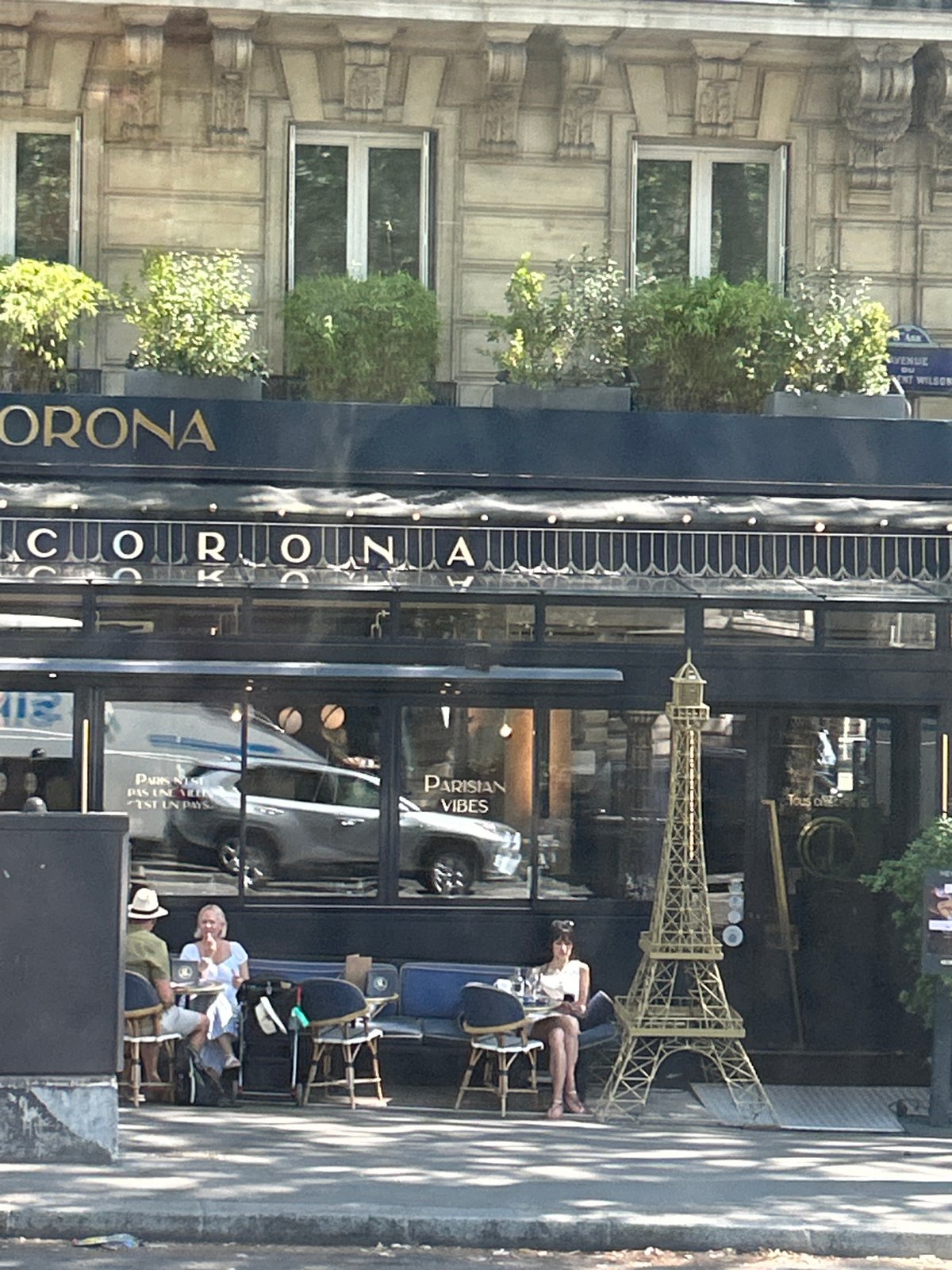 Street-level Paris morning: Eiffel Tower, markets, and café facades