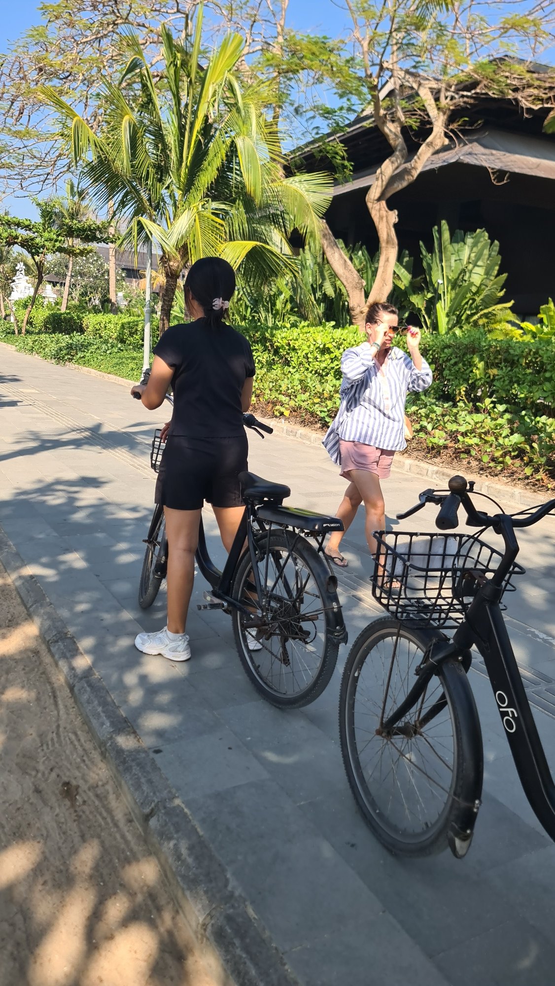 Active beach promenade scene in Denpasar, Bali