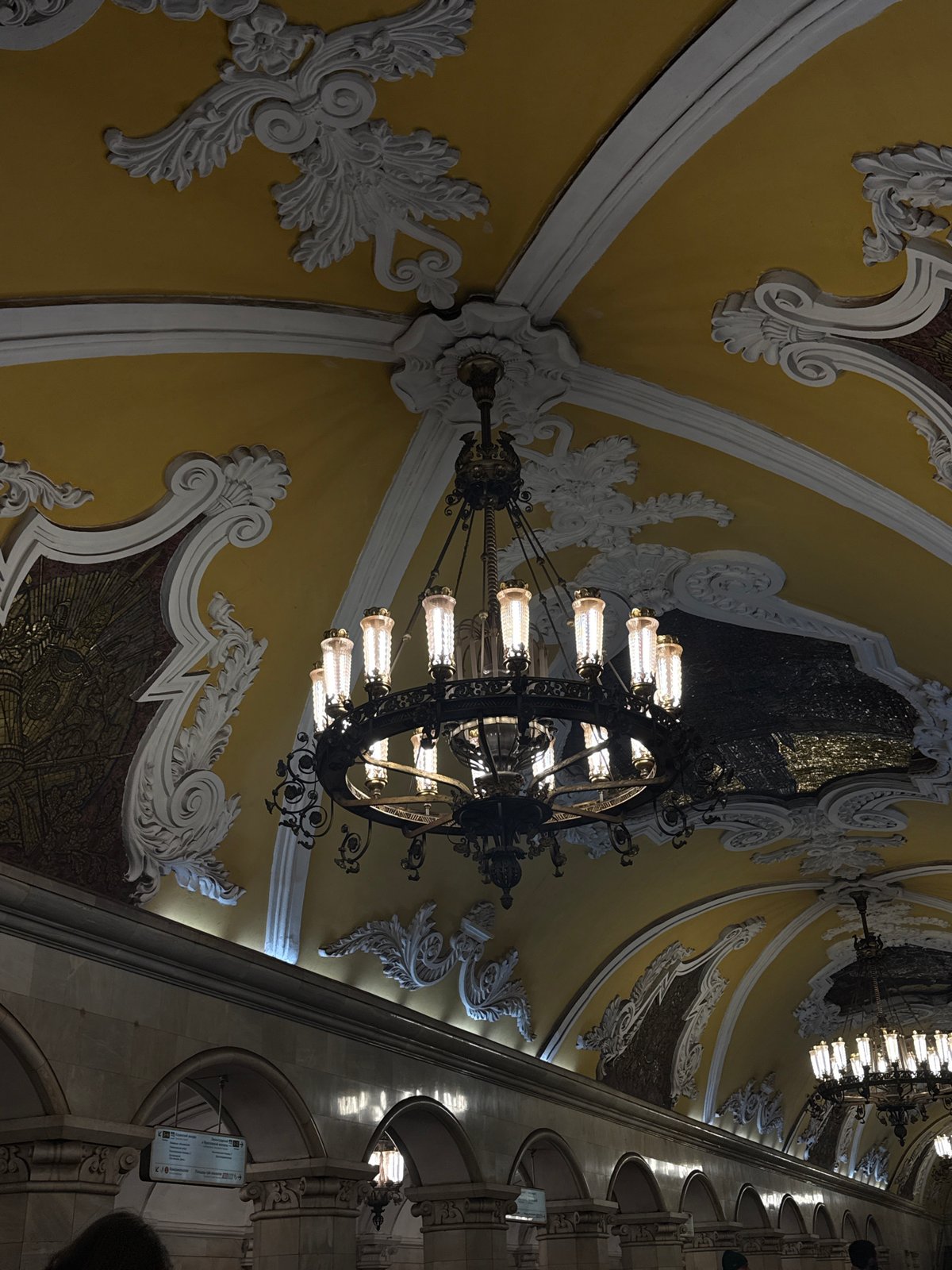 Tourist takes selfie at ornate Moscow metro station