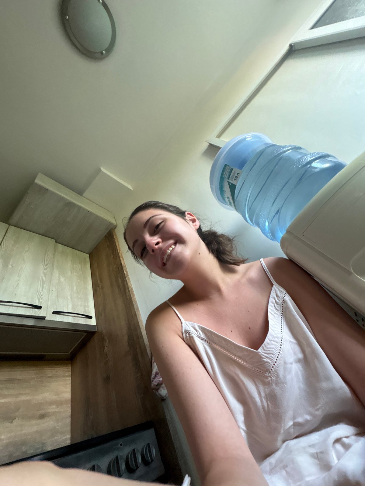 Playful kitchen selfies with a blue water jug in Bulgarovo
