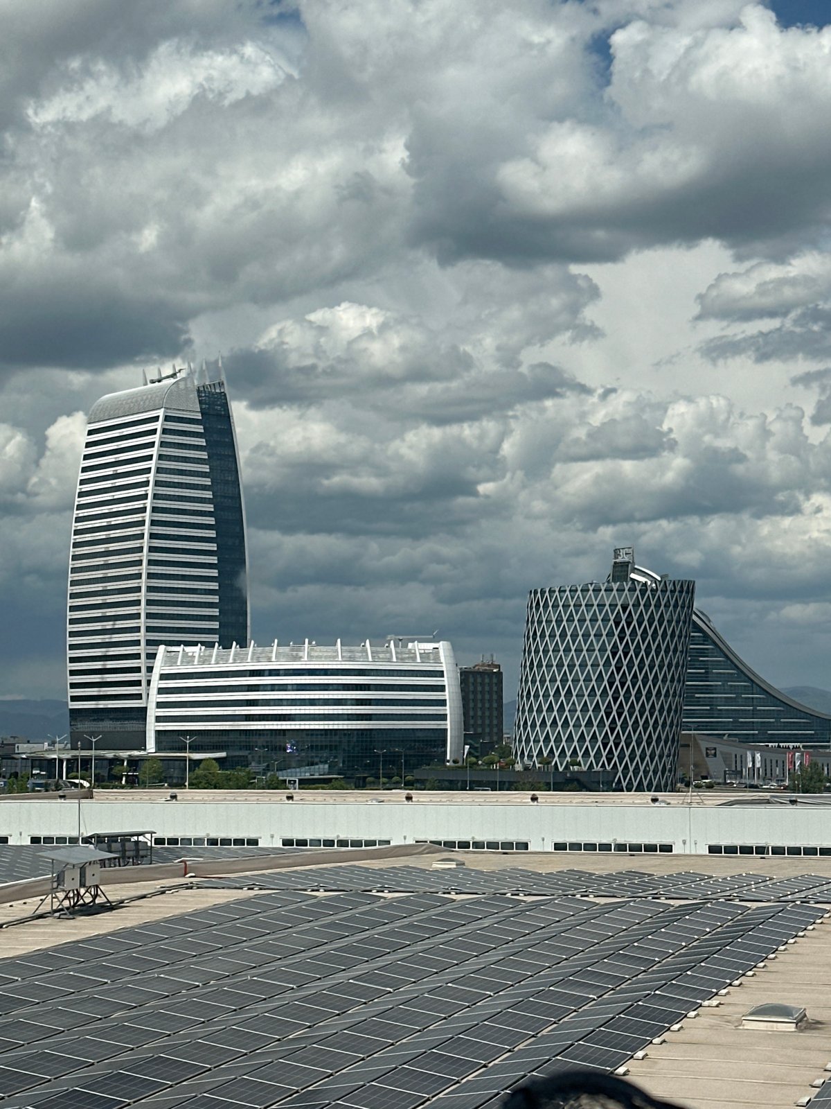 Solar-paneled building observed in Sofia cityscape under cloudy skies