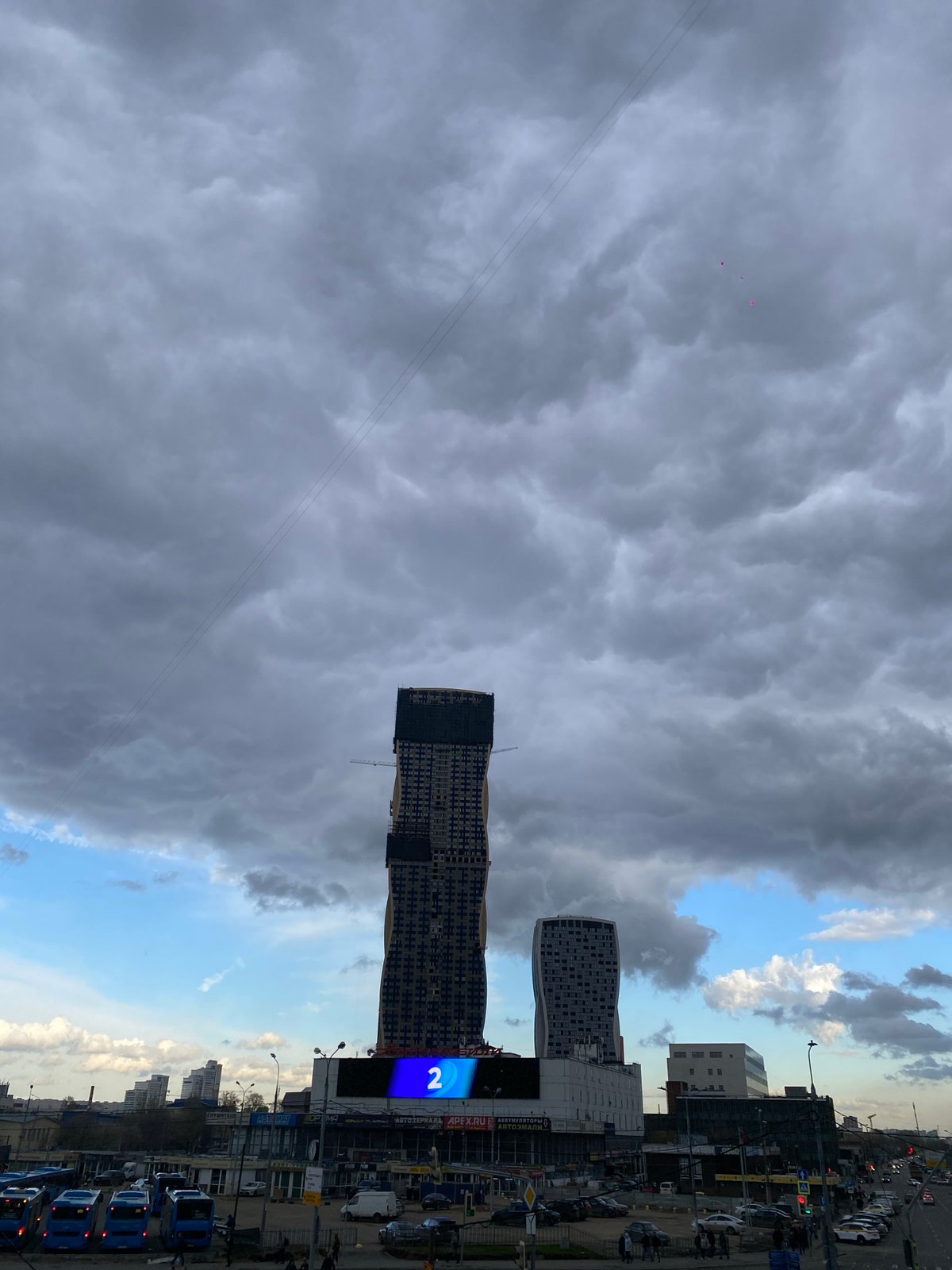 Moscow afternoon: stormy skies over construction, bakers at work