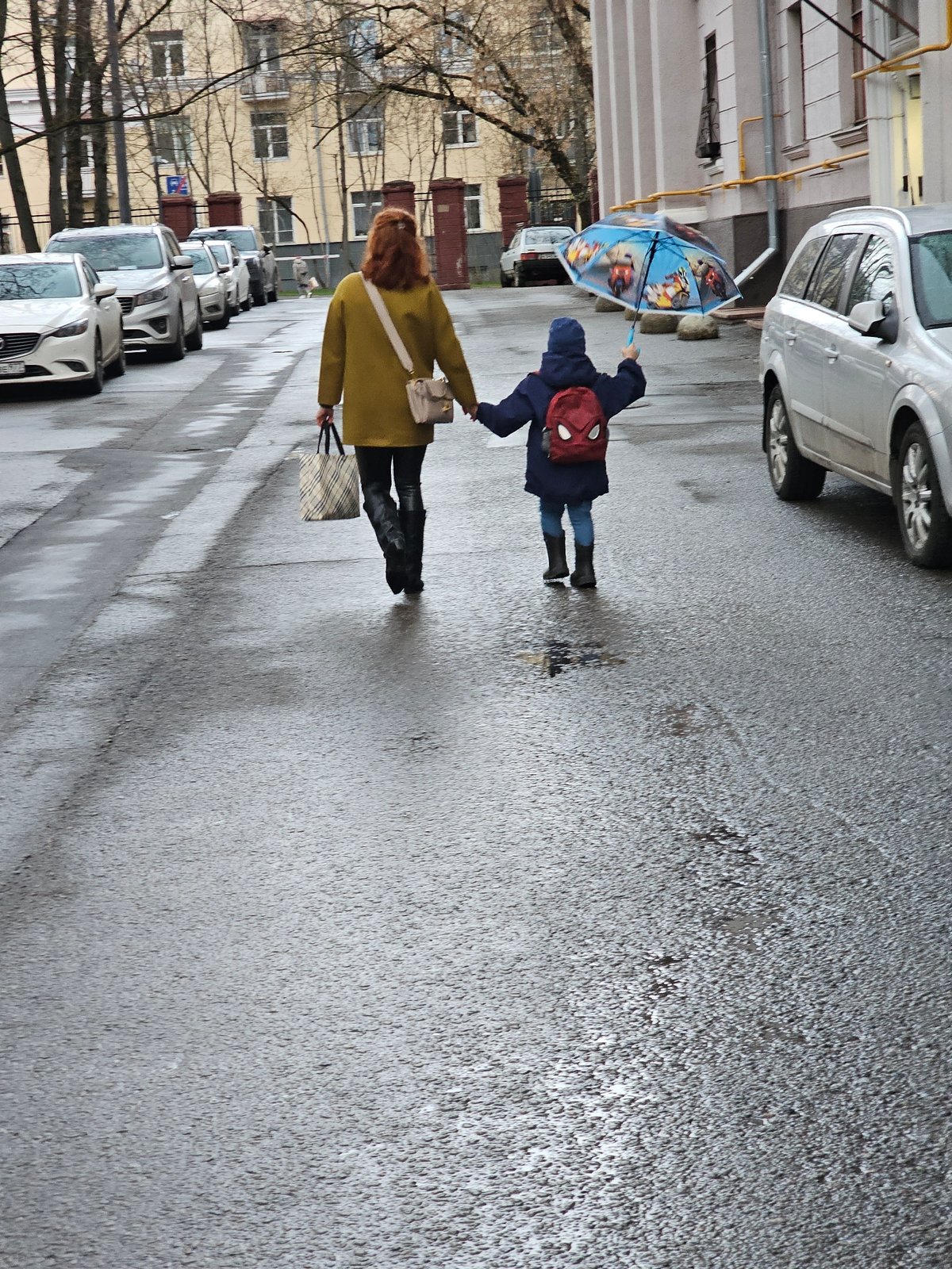 Pedestrians walk through wet streets in Khimki, Russia