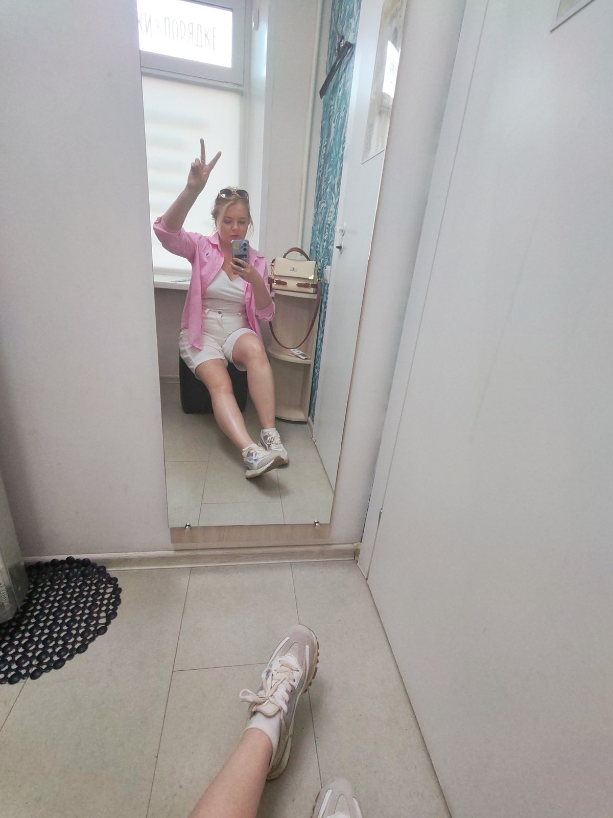 Woman documents shopping trip in Izhevsk dressing room