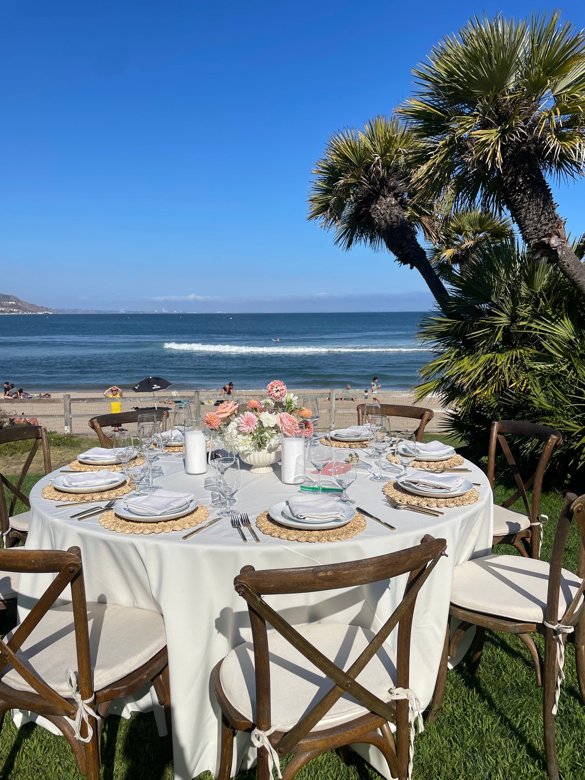 Elegant outdoor reception tables set overlooking the Malibu coast