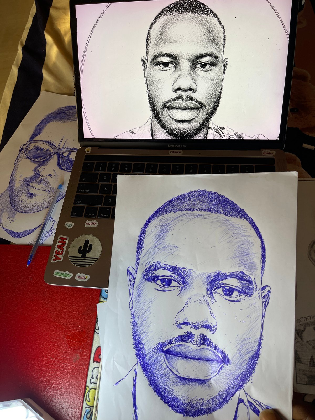 Artist sketches multiple male portraits in blue ink in Jos