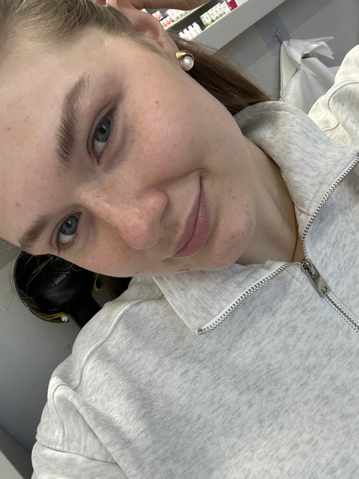 Woman Takes Selfie in Gray Hoodie and Pearl Earring