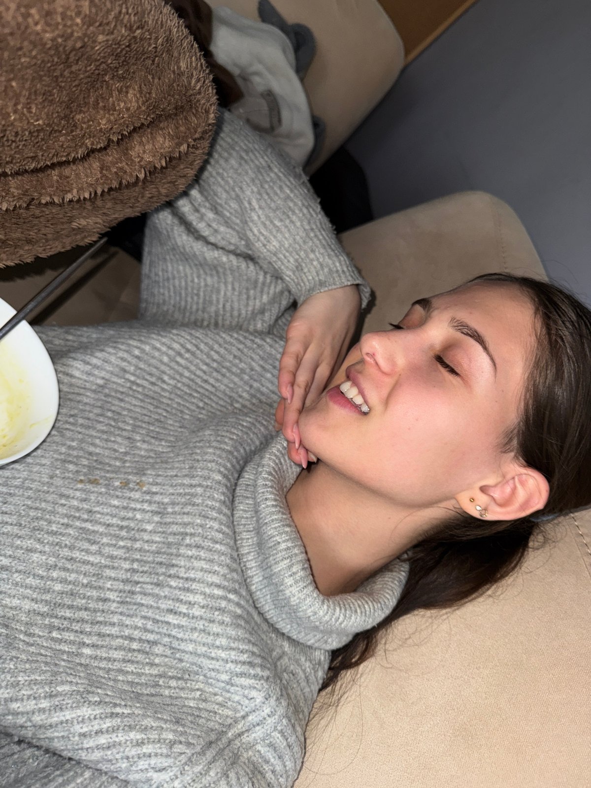 Woman rests on couch in Sofia apartment