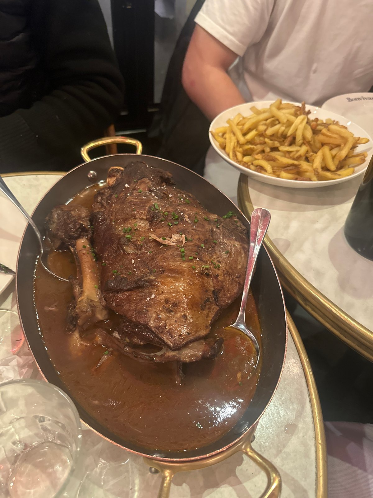 Diner enjoys braised meat dish at Paris restaurant