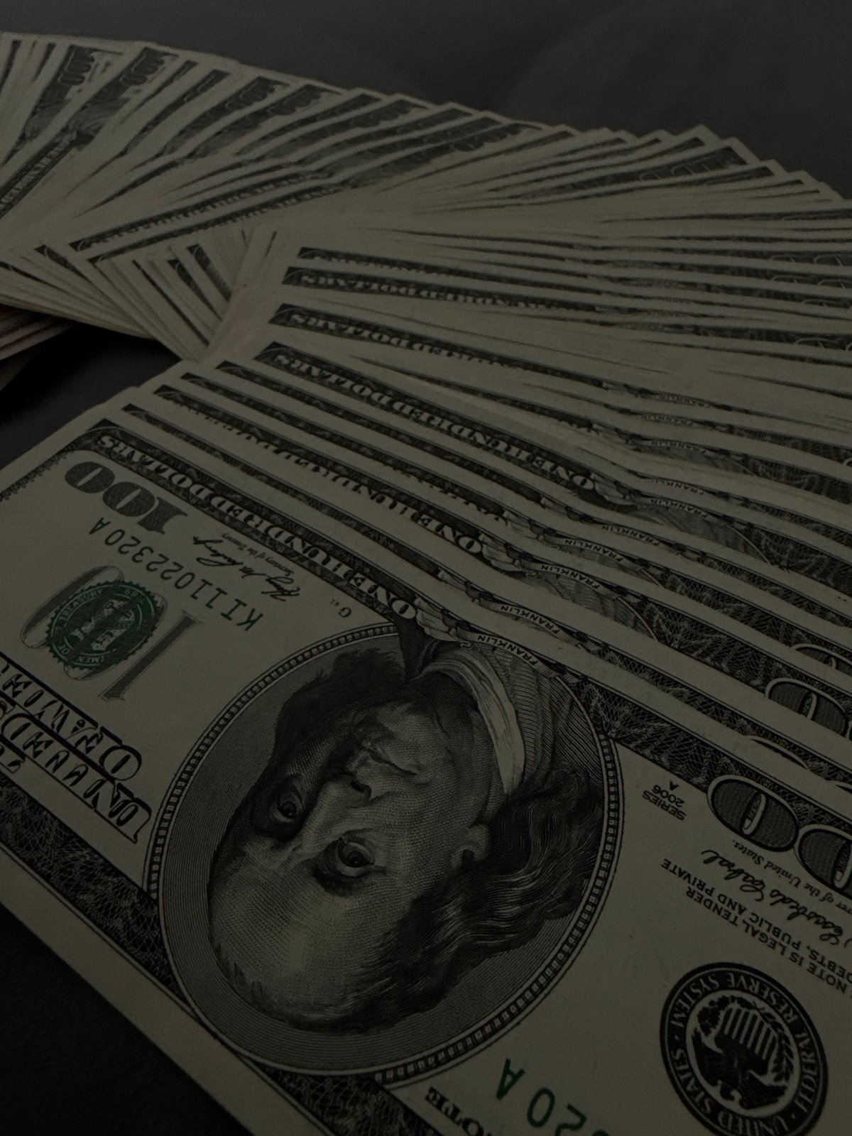 Fanned US cash, $50s and $100s, photographed multiple times in Vinnytsia
