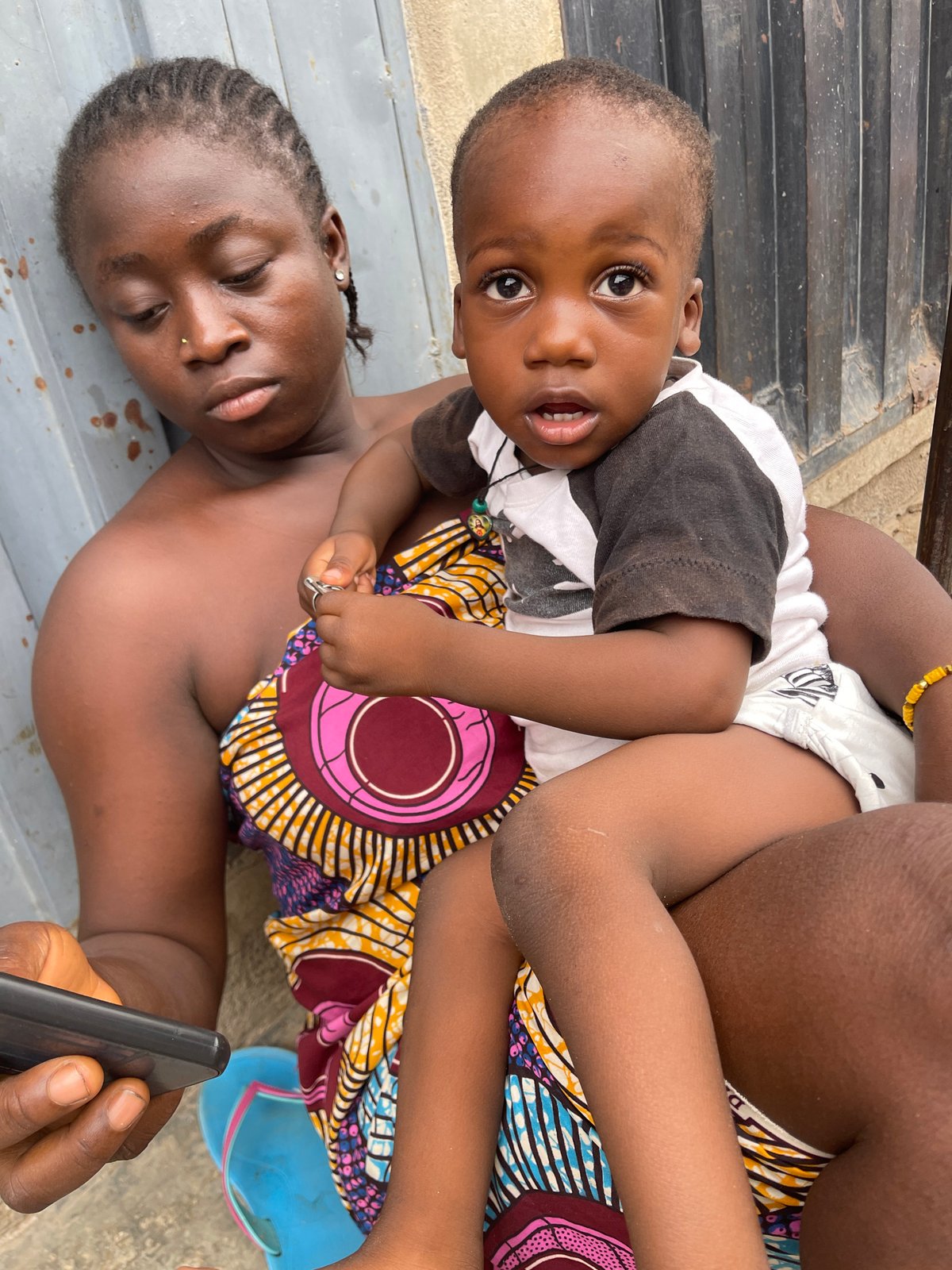 Child photographed on concrete pavement in Nyanya, Nigeria