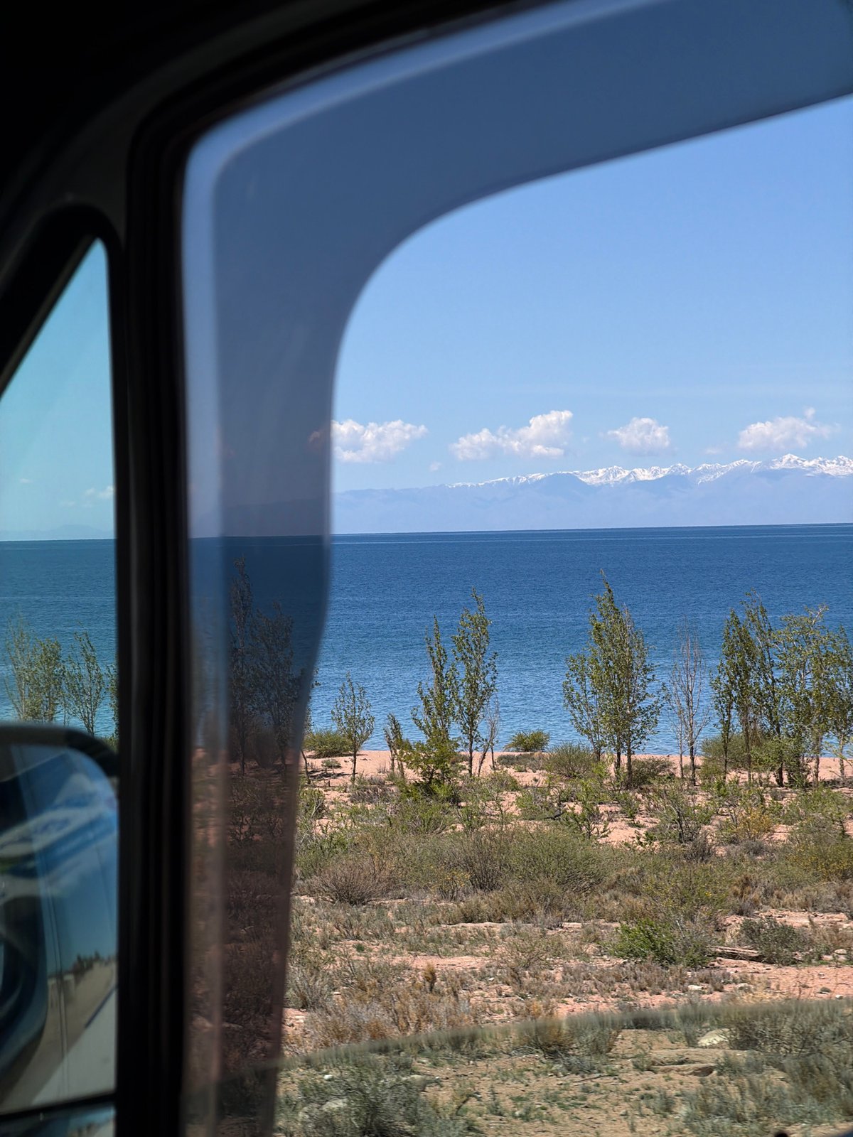 Vehicle passenger captures landscape view in Kaji-Say, Kyrgyzstan