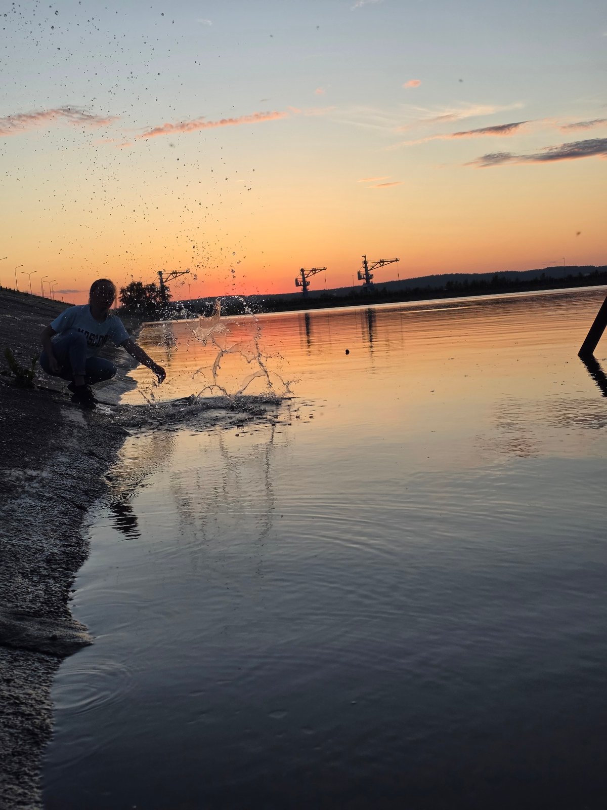 Sunset documented along Chaikovsky Russia waterfront and industrial port