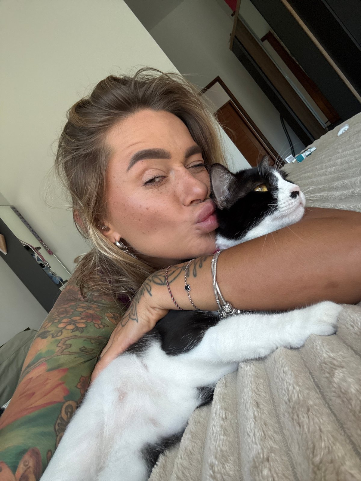 Woman shows affection to cat in Thailand bedroom