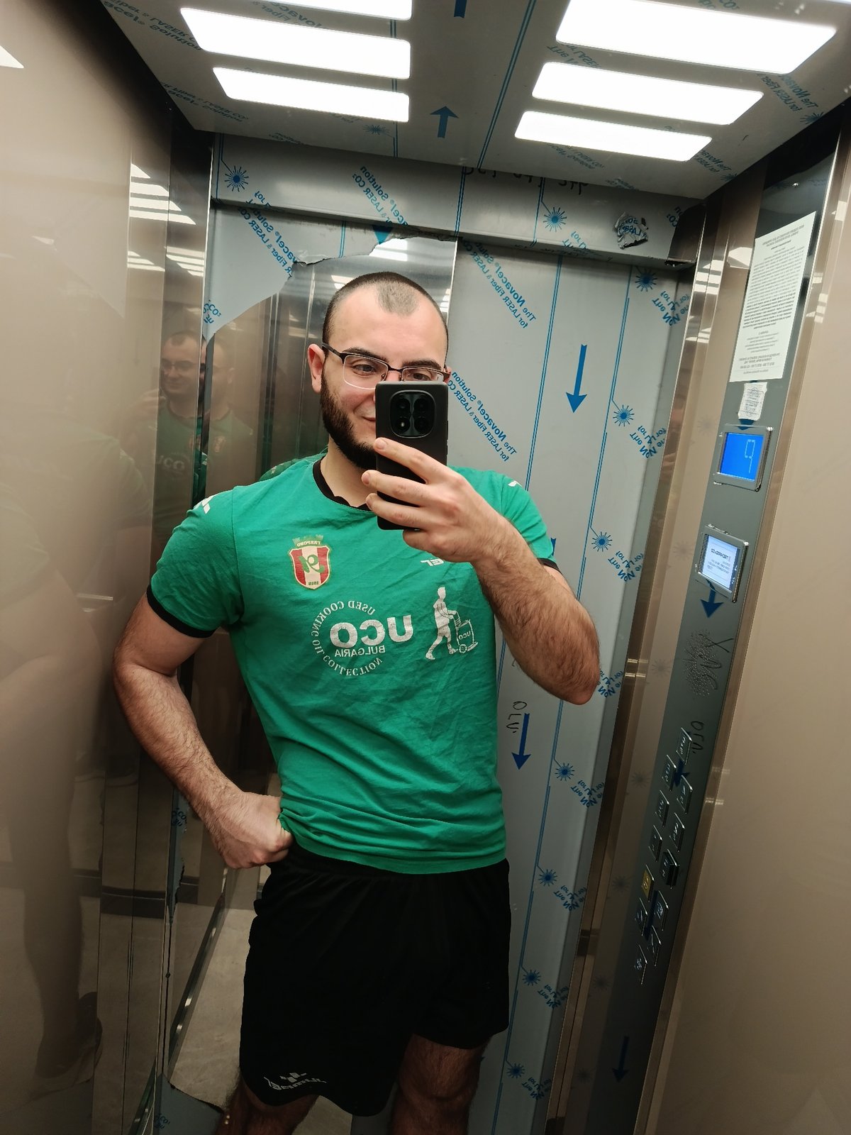 Man takes elevator selfie in Plovdiv wearing UCO shirt