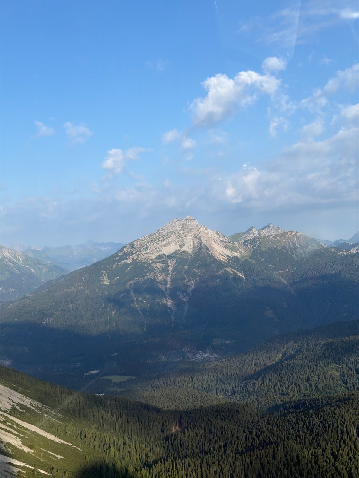Cable car and rocky alpine landscape above Grainau on a clear morning