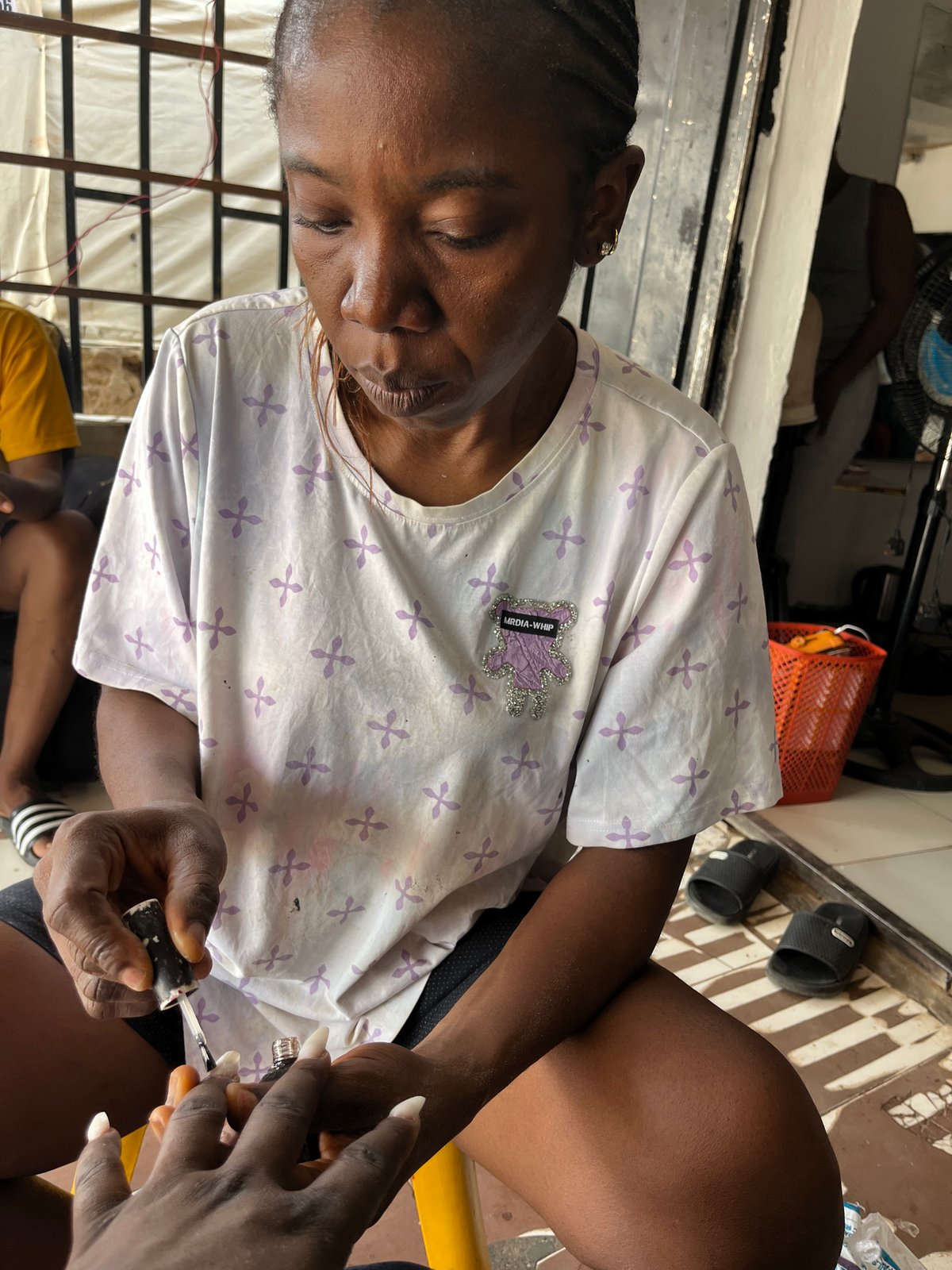 Morning street life and beauty services documented across Abuja