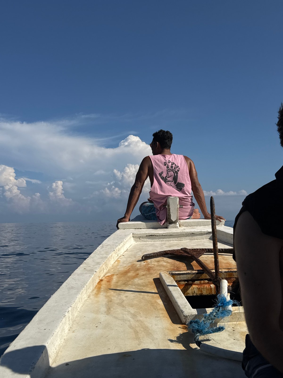Man sits on boat edge in Indonesia