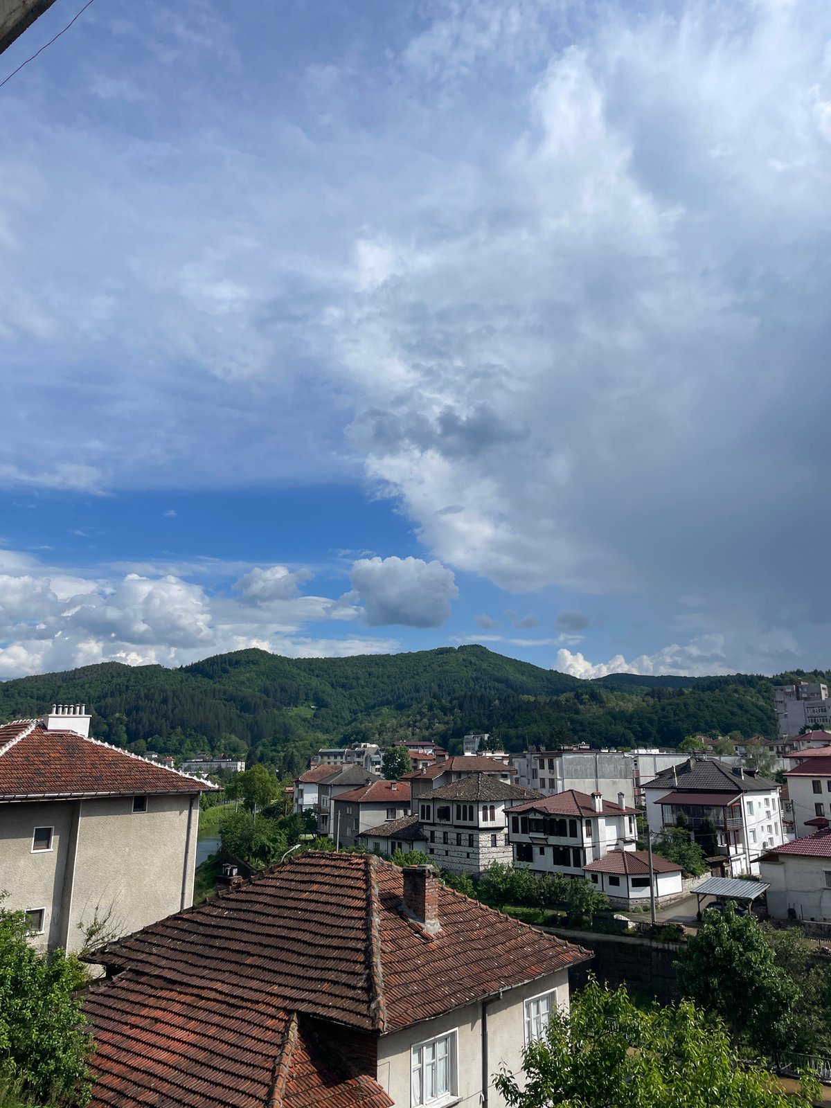 Man does yard work in Bulgarian mountain town