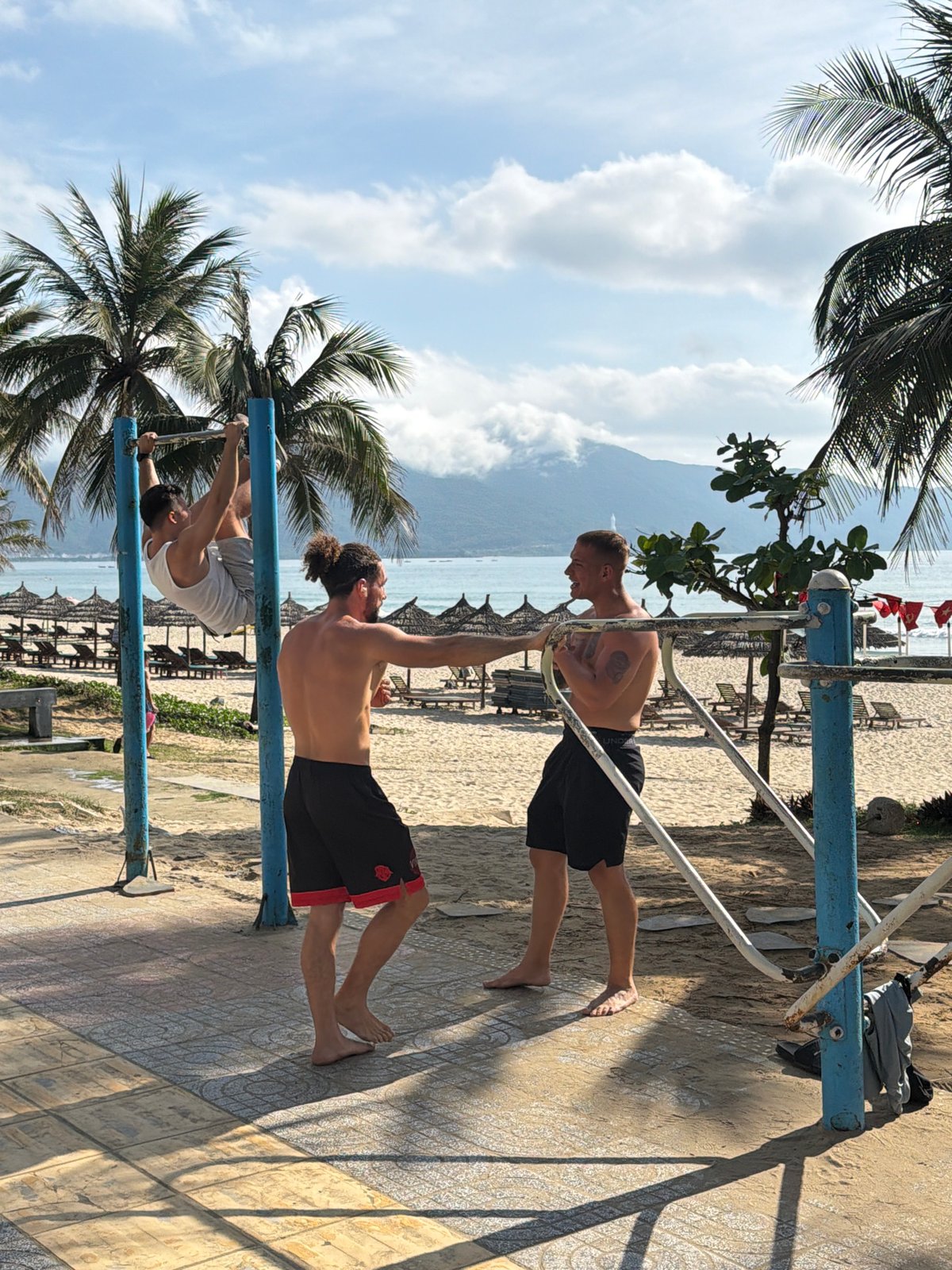 Men exercise on parallel bars in Đà Nẵng Vietnam