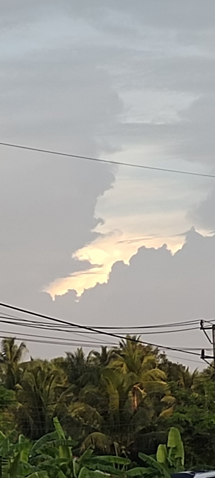 Overcast skies give way to sunset in Indonesian village