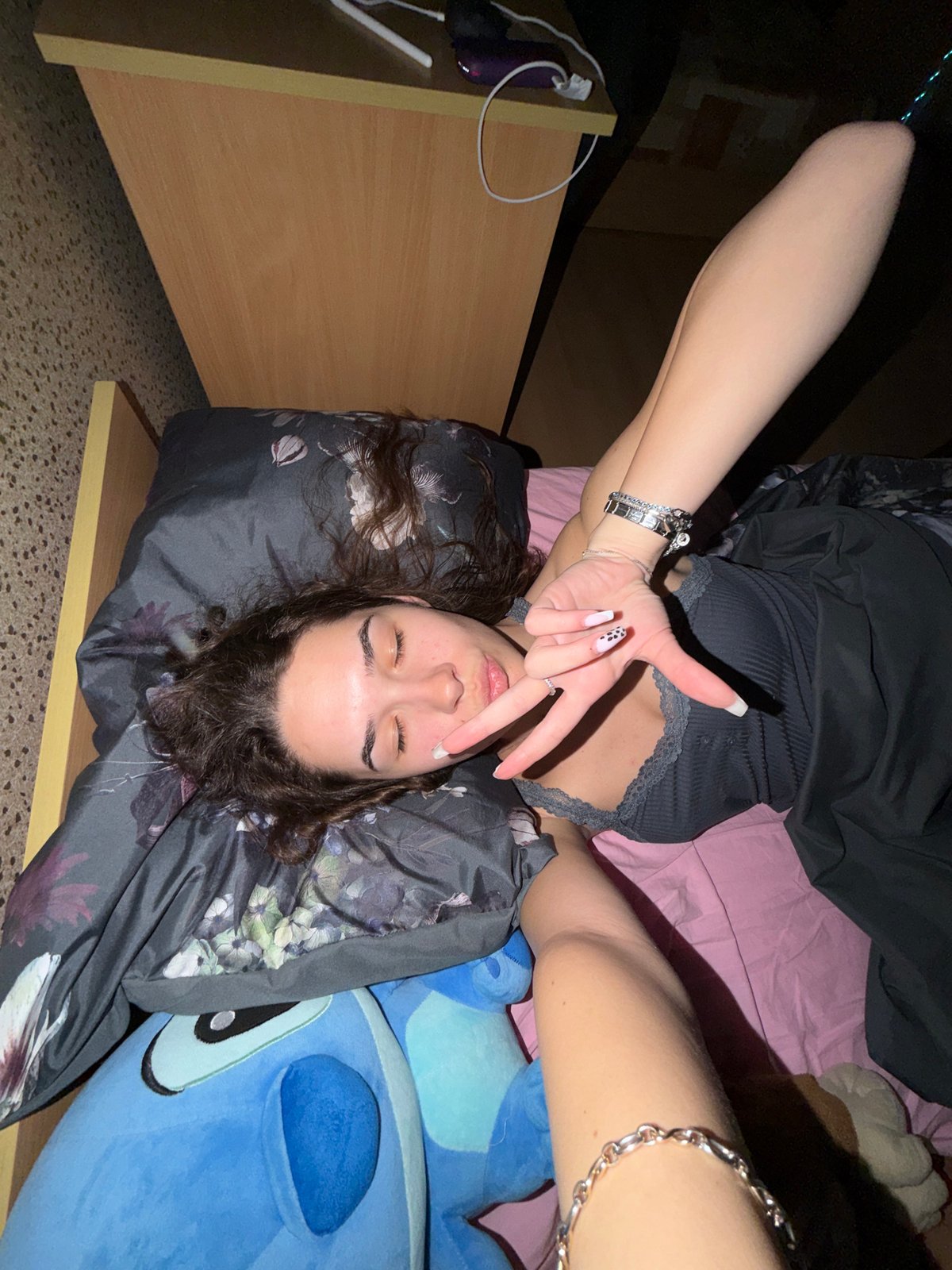 Young woman takes multiple selfies lying down in Sofia